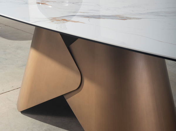 Oval dining table with porcelain marble barrel and bronze-colored steel barrel