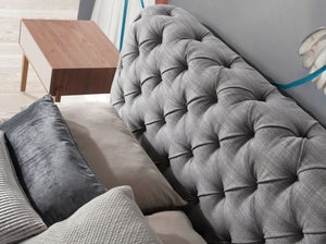 Bed upholstered in gray fabric