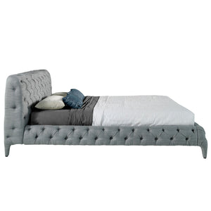 Bed upholstered in gray fabric