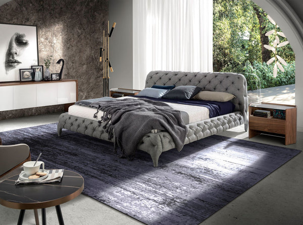 Bed upholstered in gray fabric