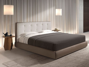 Bed upholstered in brown fabric and brown synthetic leather