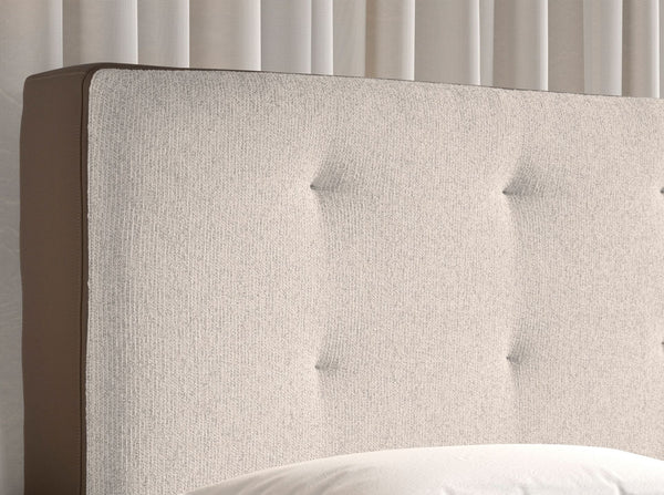 Bed upholstered in brown fabric and brown synthetic leather