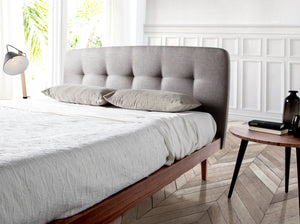 Tufted bed in gray fabric