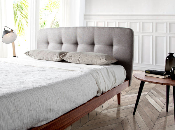 Tufted bed in gray fabric